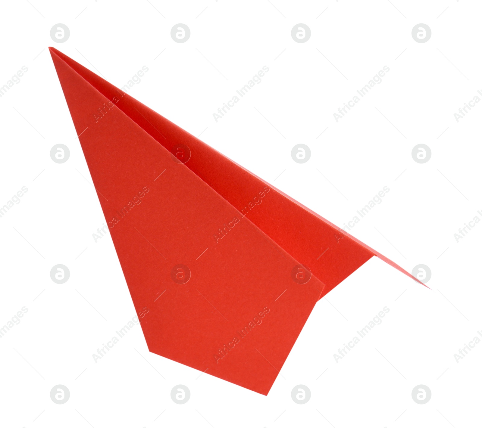 Photo of One handmade coral paper plane isolated on white