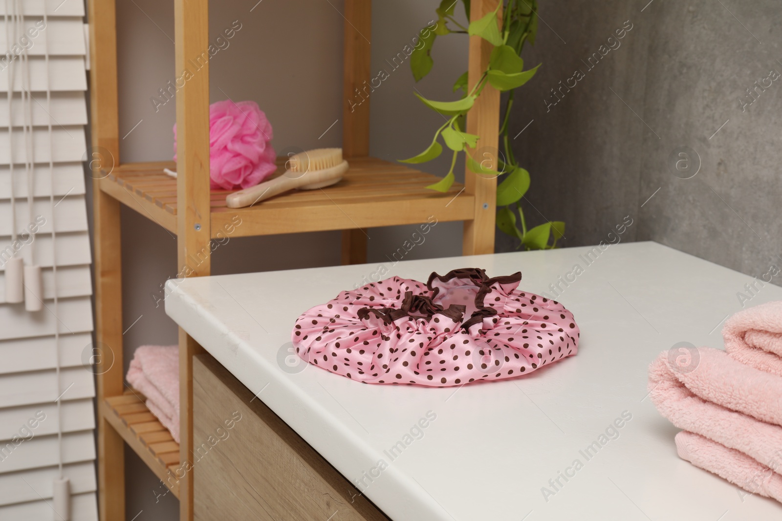 Photo of Shower cap and bath accessories in bathroom