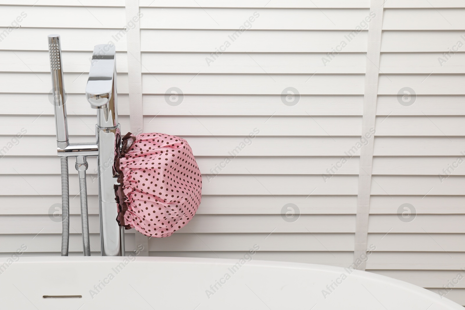 Photo of Shower cap in bathroom, space for text