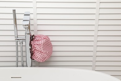 Shower cap in bathroom, space for text