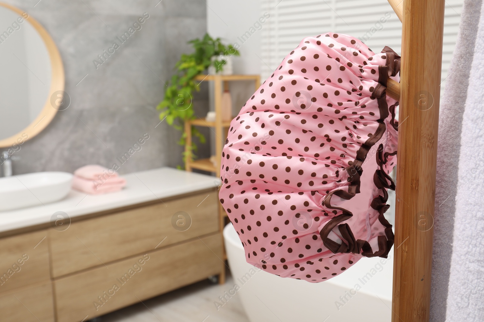 Photo of Shower cap and towel on rack in bathroom