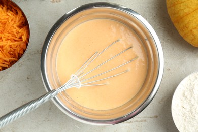 Photo of Bowl with dough and ingredients for pumpkin pancakes on light table, flat lay