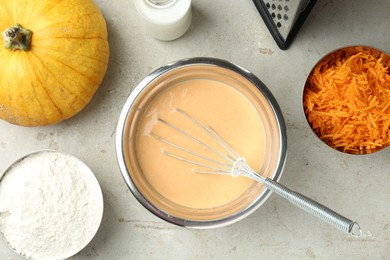 Photo of Bowl with dough and ingredients for pumpkin pancakes on light table, flat lay