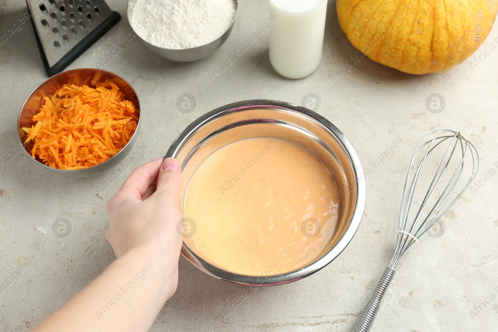 Photo of Woman making pumpkin pancakes at light table, closeup