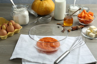 Photo of Different ingredients for pumpkin pancakes on wooden table