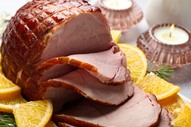 Tasty baked ham served on white table, closeup