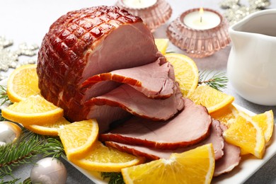 Photo of Tasty baked ham served on white table, closeup