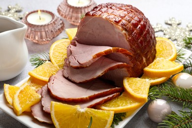 Photo of Tasty baked ham served on white table, closeup