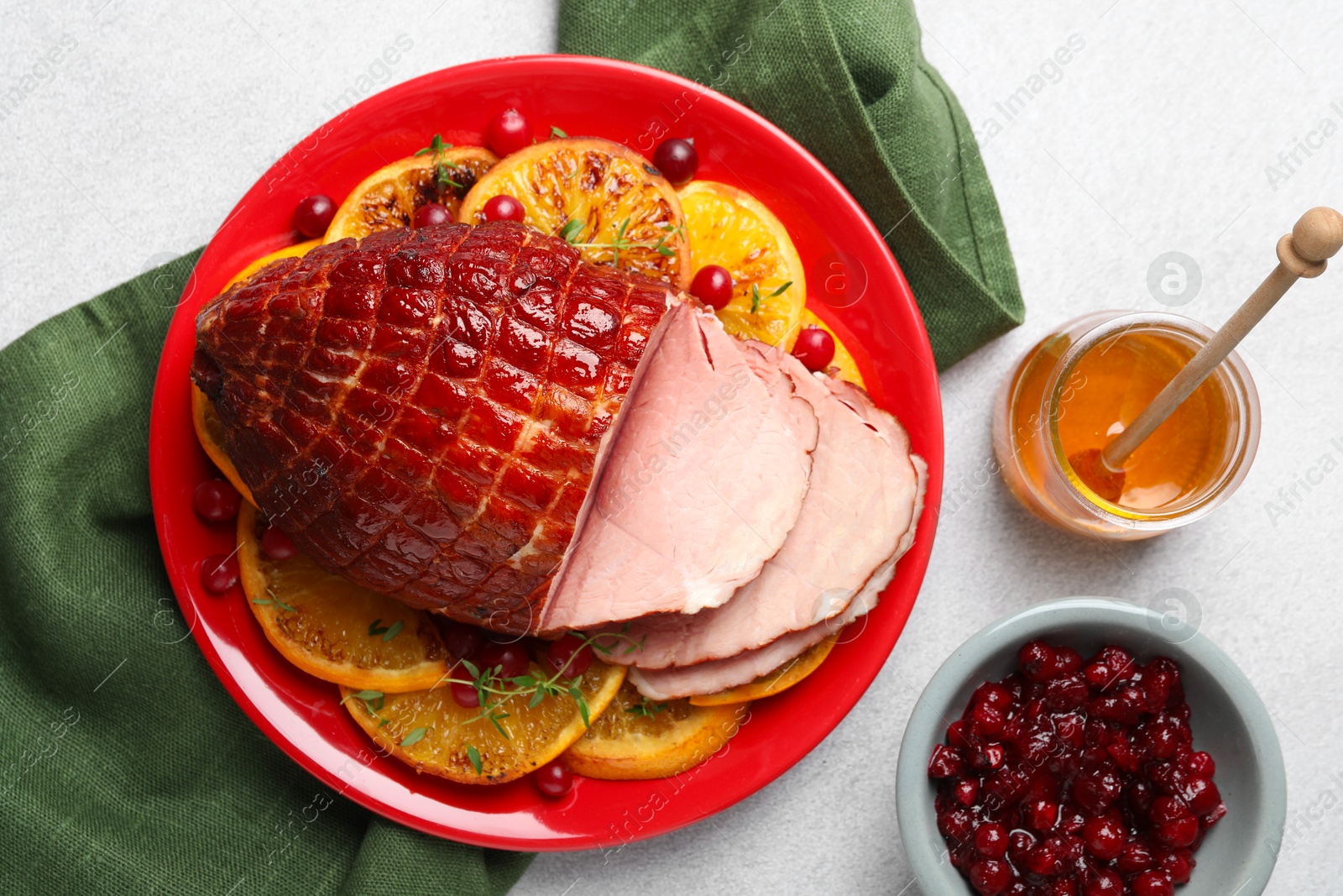 Photo of Tasty baked ham served on white table, flat lay