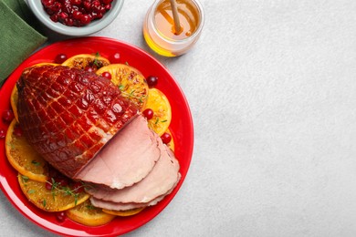 Photo of Tasty baked ham served on white table, flat lay. Space for text