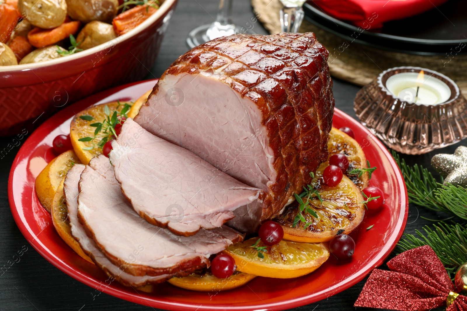 Photo of Tasty baked ham served on black wooden table