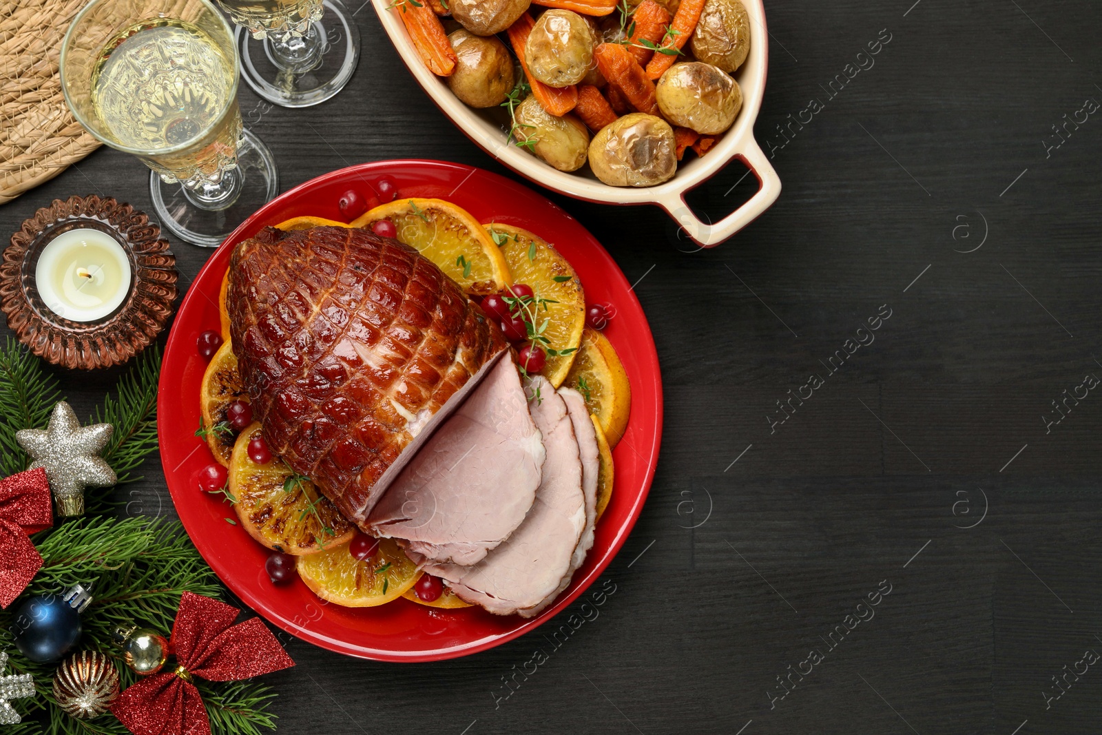 Photo of Tasty baked ham served on black wooden table, flat lay. Space for text