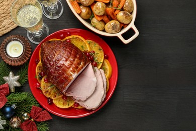 Tasty baked ham served on black wooden table, flat lay. Space for text