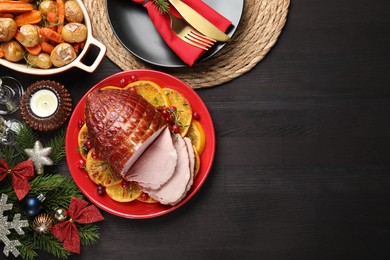 Tasty baked ham served on black wooden table, flat lay. Space for text