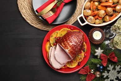 Photo of Tasty baked ham served on black wooden table, flat lay. Space for text