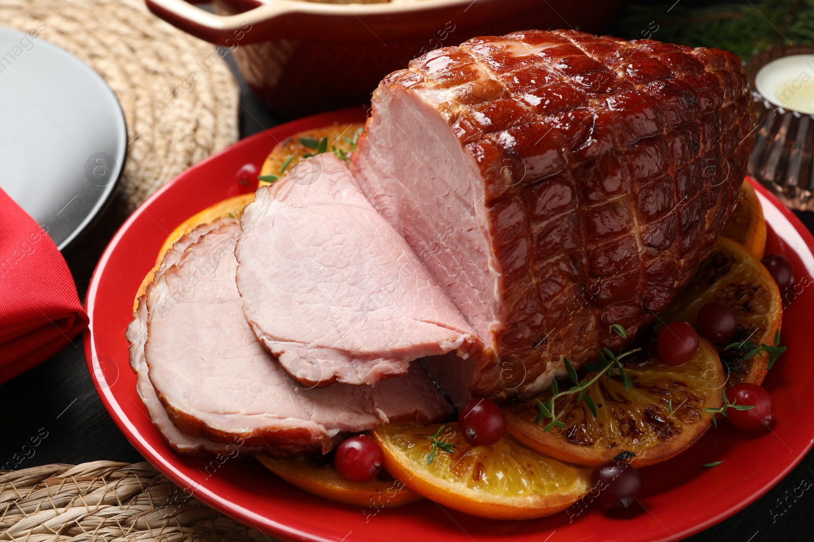 Photo of Tasty baked ham served on black wooden table, closeup