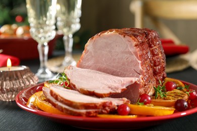 Photo of Tasty baked ham served on black wooden table, closeup