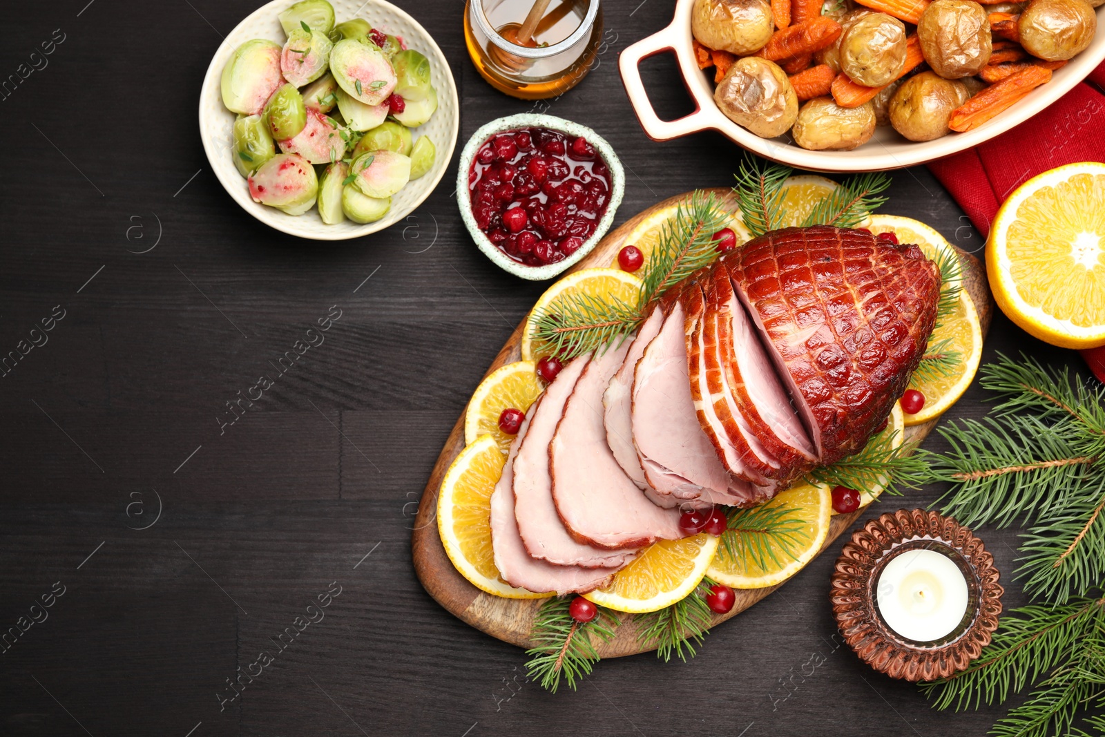 Photo of Tasty baked ham served on black wooden table, flat lay. Space for text