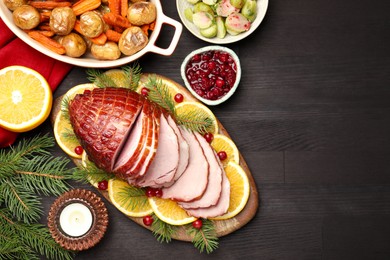 Photo of Tasty baked ham served on black wooden table, flat lay. Space for text