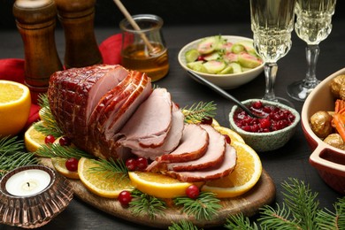 Tasty baked ham served on black wooden table