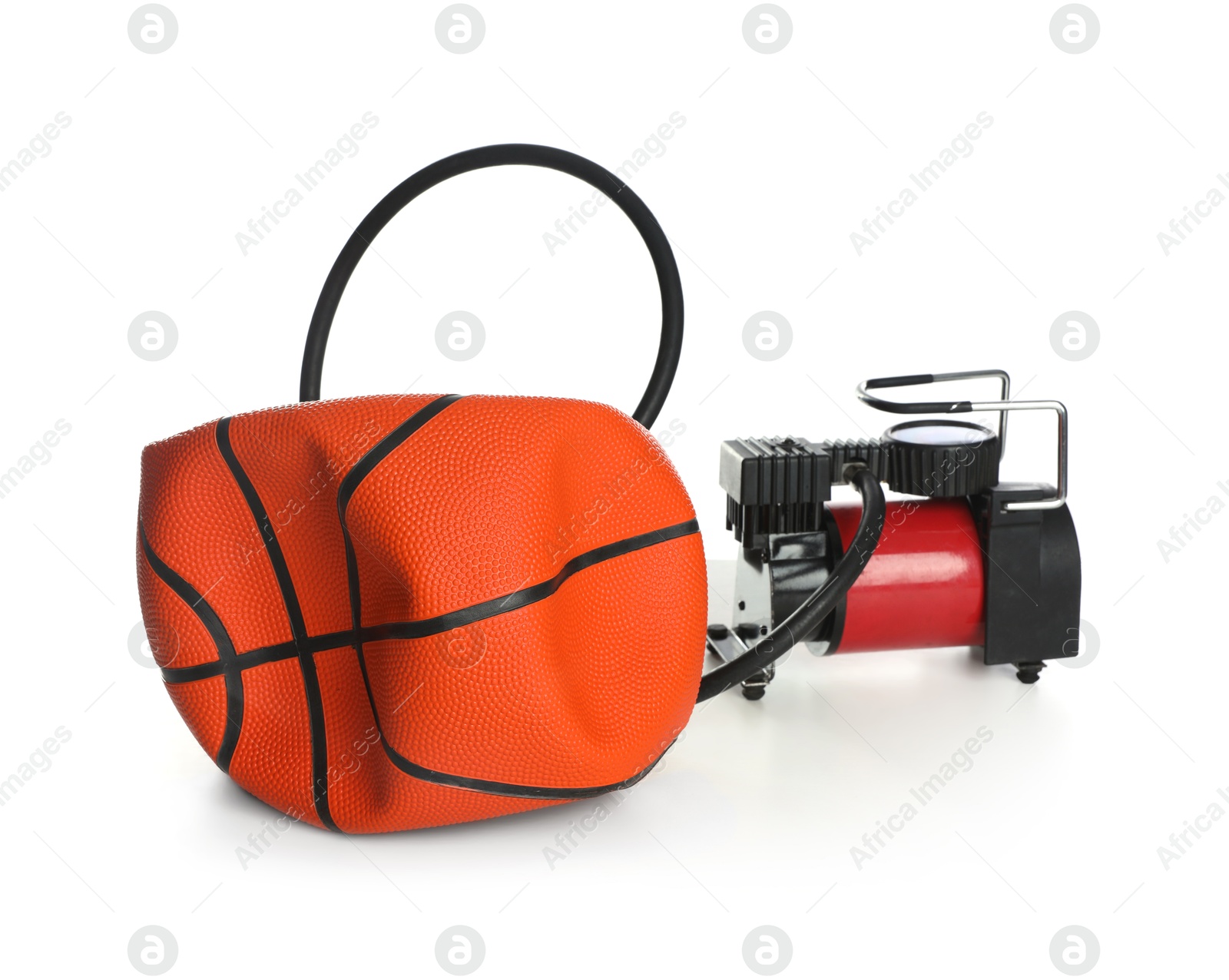 Photo of Deflated basketball ball and air compressor isolated on white