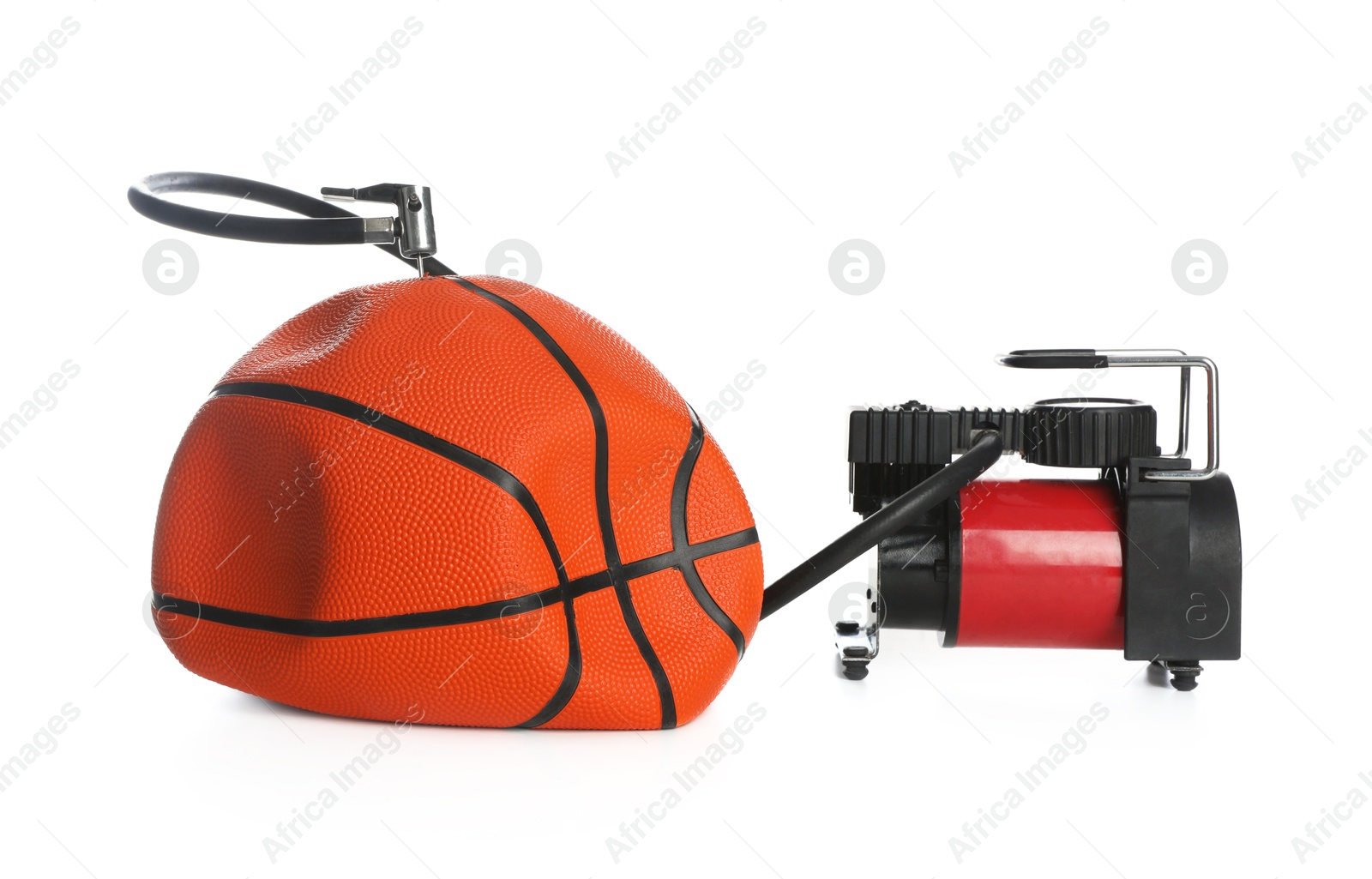 Photo of Deflated basketball ball and air compressor isolated on white