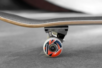 Photo of One modern skateboard on ground outdoors, closeup