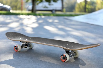 Photo of One skateboard with black griptape in modern skatepark