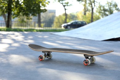 Photo of One modern skateboard with black griptape in skatepark