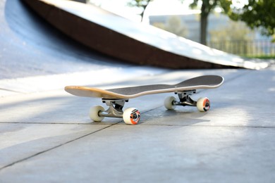 Photo of One modern skateboard with black griptape in skatepark