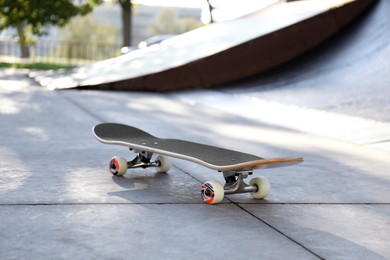 Photo of One modern skateboard with black griptape in skatepark