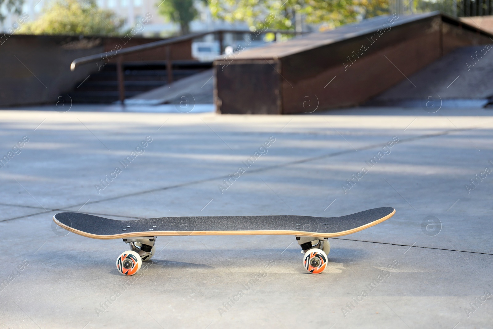 Photo of One modern skateboard with black griptape in skatepark