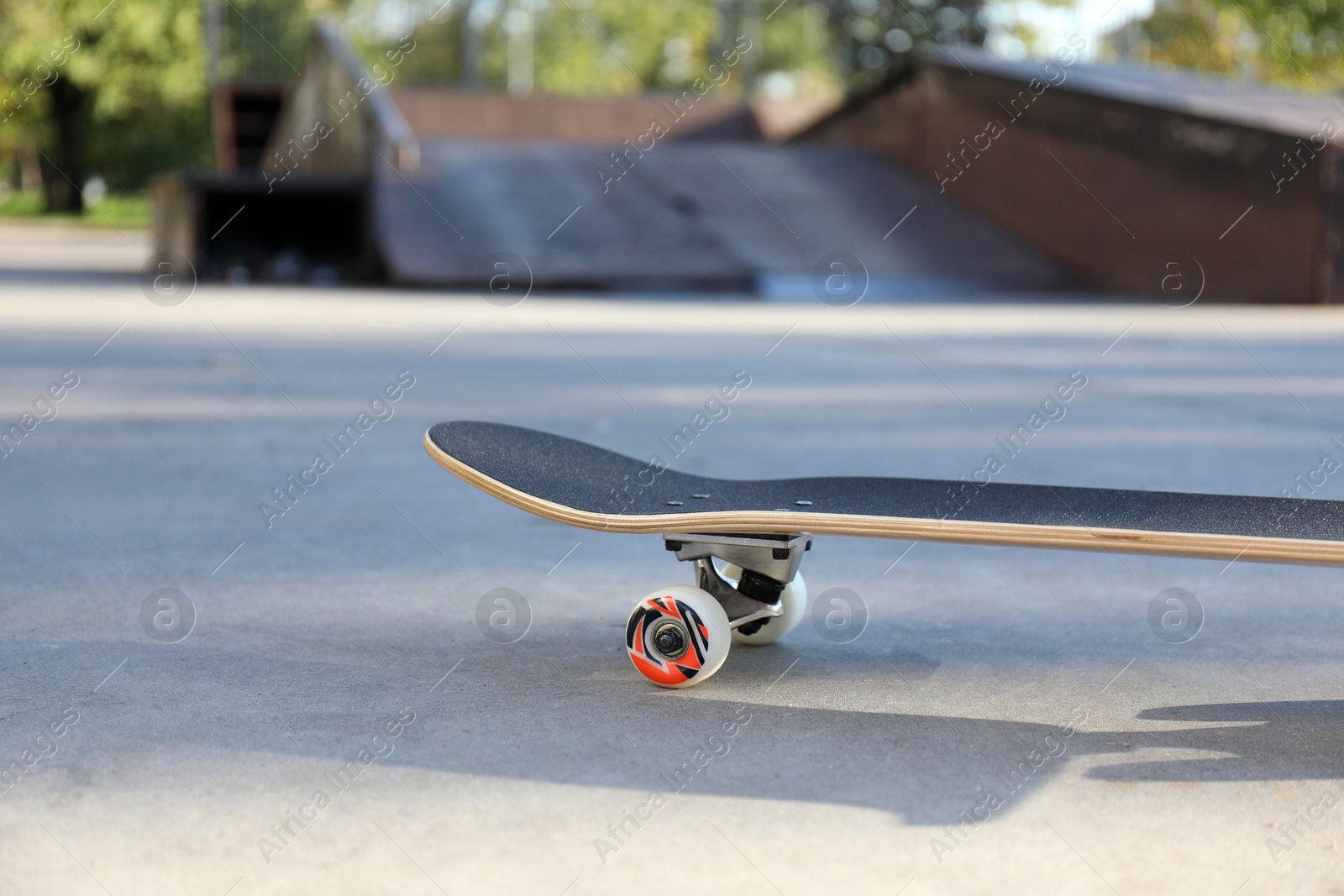 Photo of One skateboard with black griptape in modern skatepark