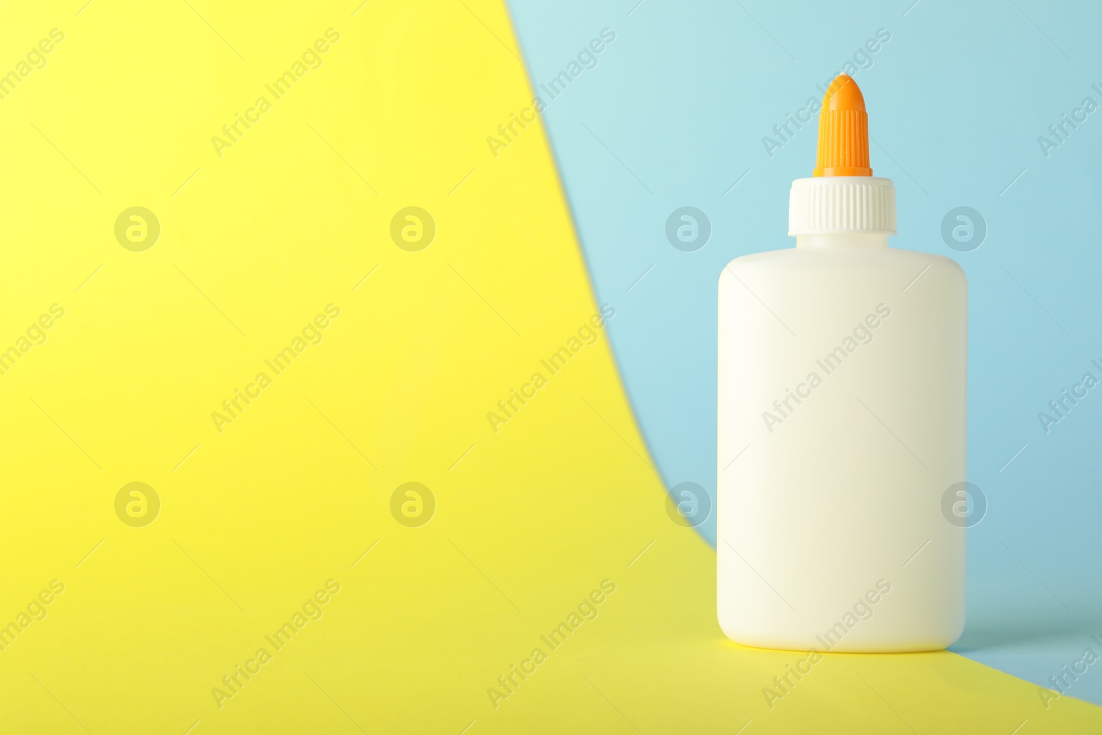 Photo of One bottle of glue on color background, space for text