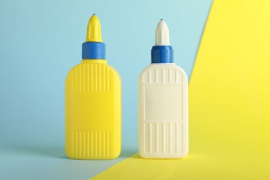 Photo of Two bottles of glue on color background