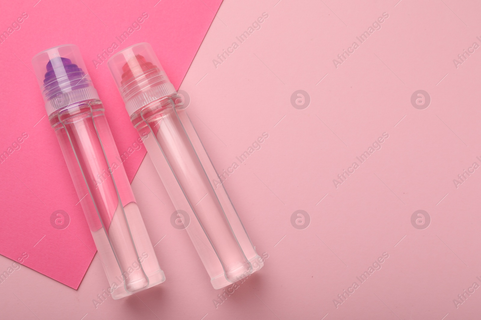 Photo of Sticks of glue on pink background, top view. Space for text