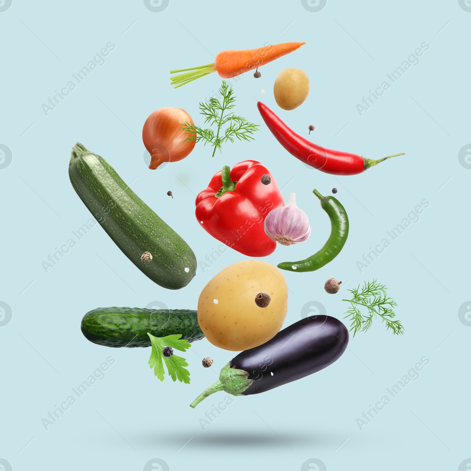 Image of Fresh vegetables, herbs and spices in air on light blue background