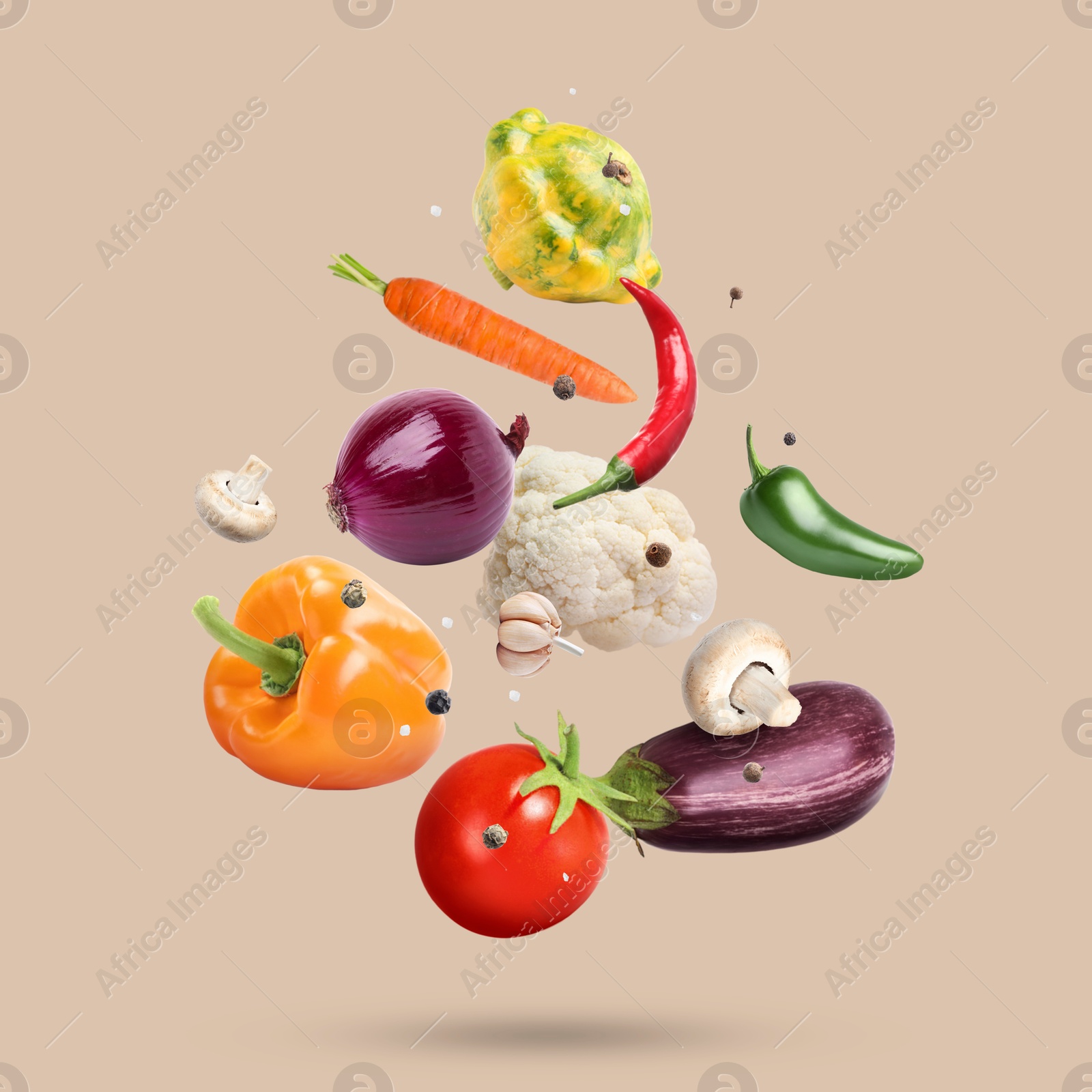 Image of Fresh vegetables and spices in air on beige background