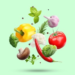 Image of Fresh vegetables, herbs and spices in air on aquamarine color background