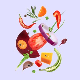 Image of Fresh vegetables, herbs and spices in air on light violet background