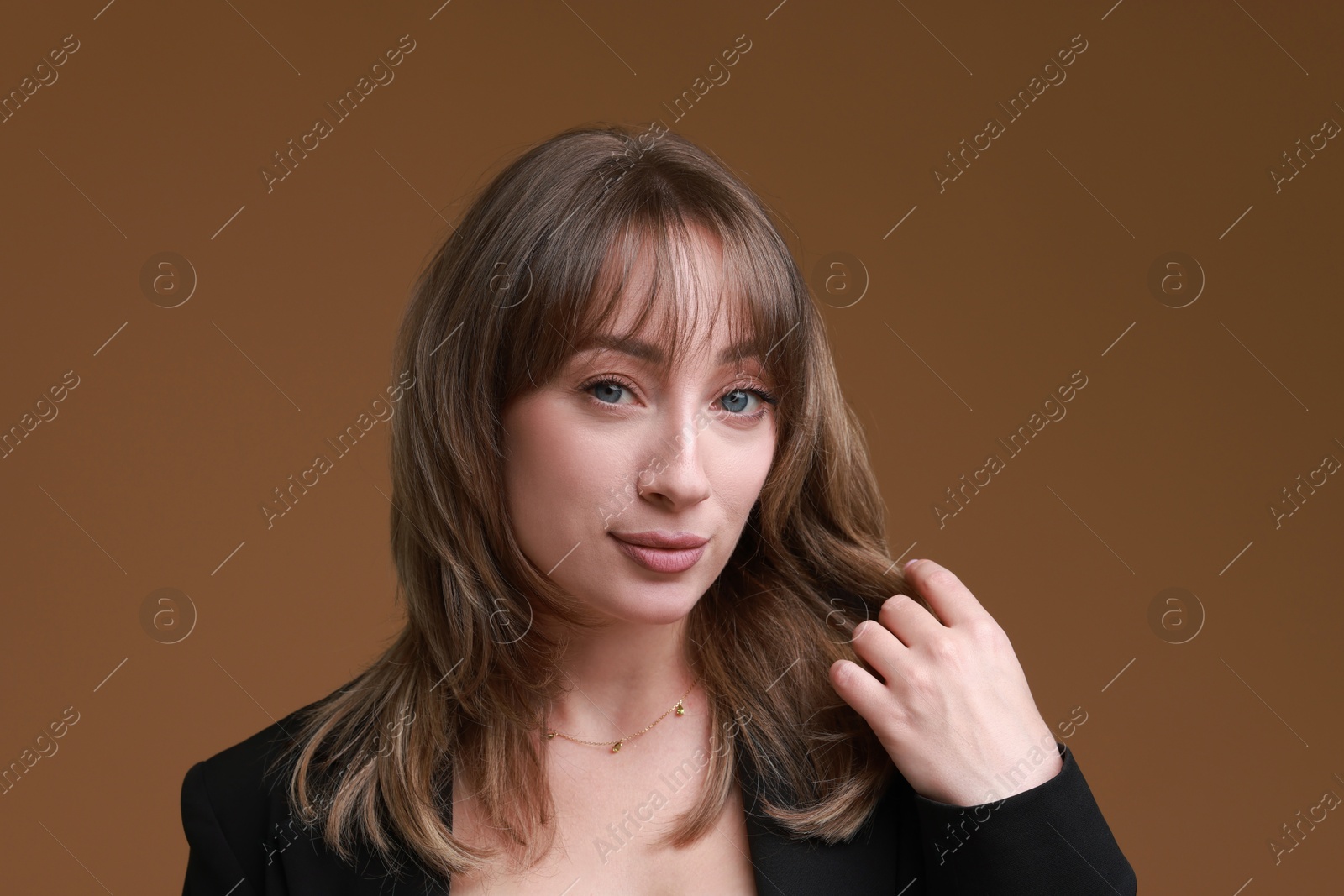 Photo of Attractive woman with stylish haircut on brown background