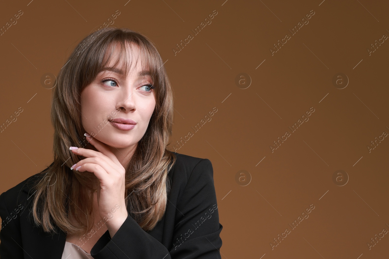 Photo of Attractive woman with stylish haircut on brown background, space for text