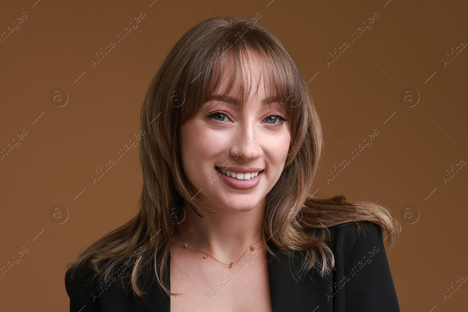 Photo of Attractive woman with stylish haircut on brown background