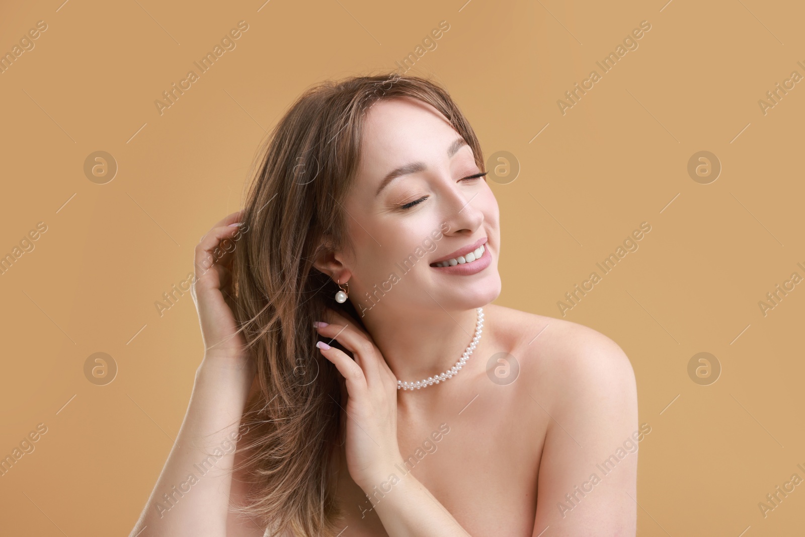 Photo of Attractive woman with stylish haircut on beige background