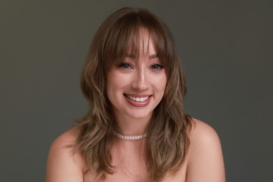 Photo of Attractive woman with stylish haircut on grey background