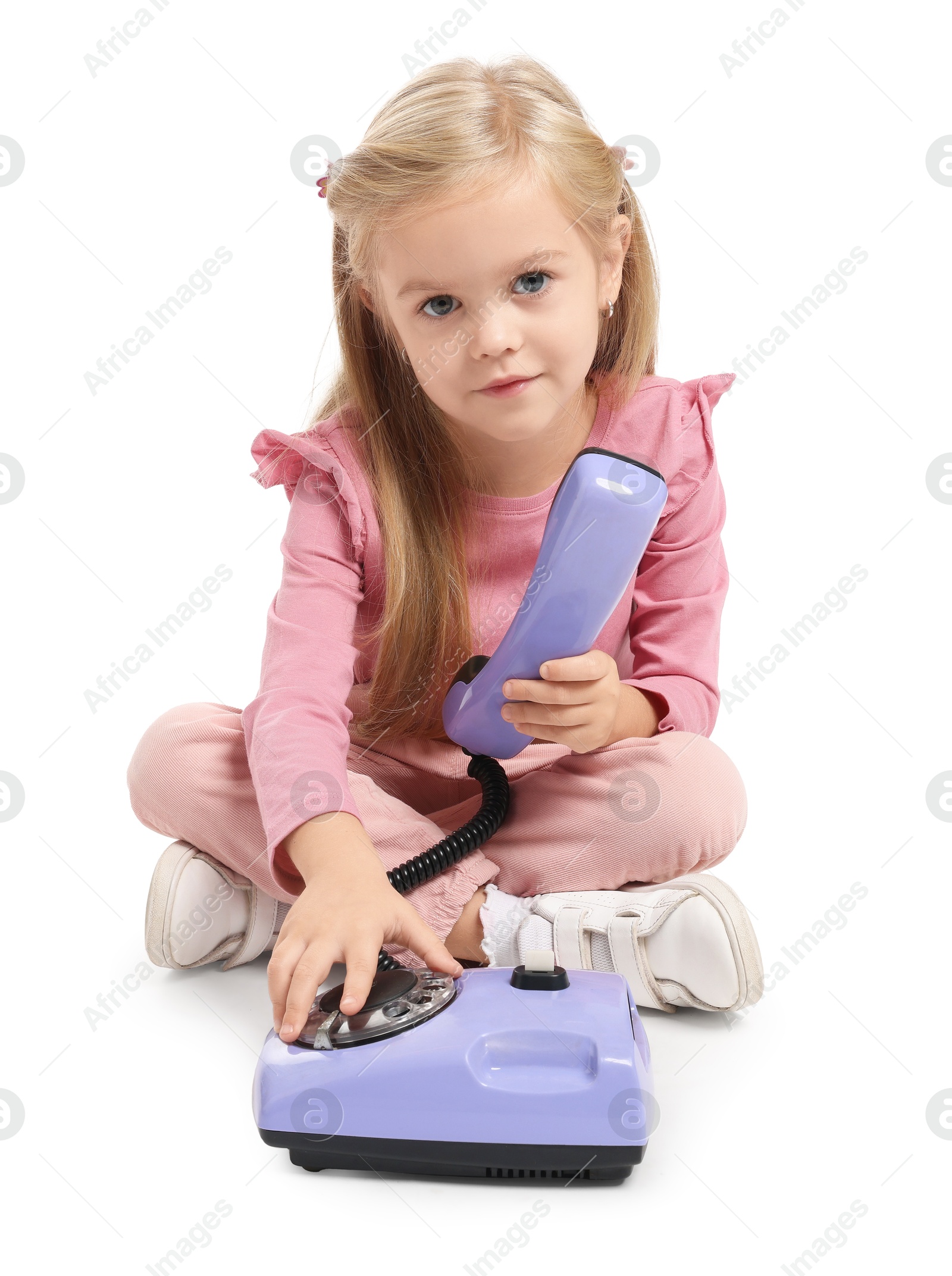 Photo of Cute little girl with telephone on white background