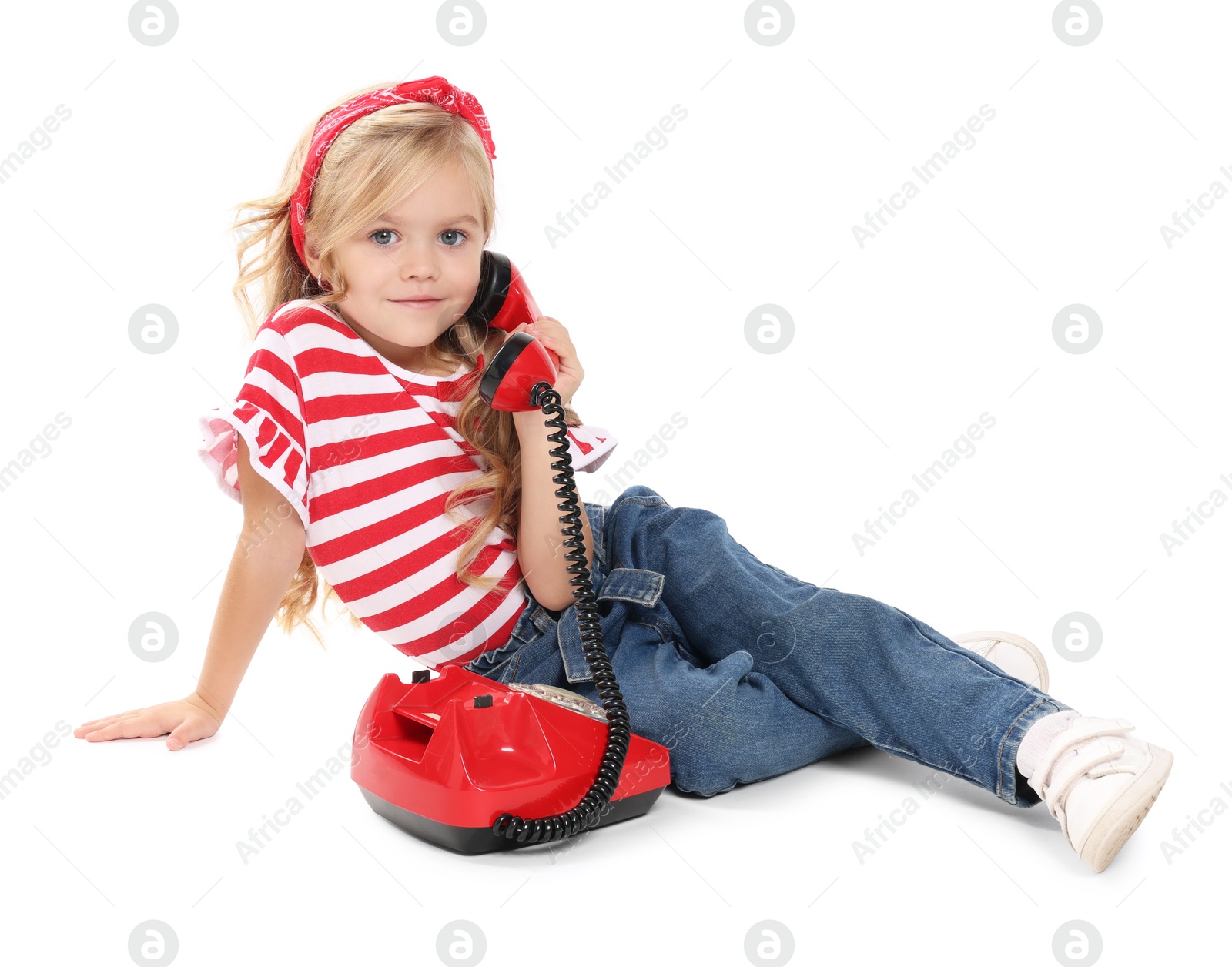 Photo of Cute little girl with telephone on white background