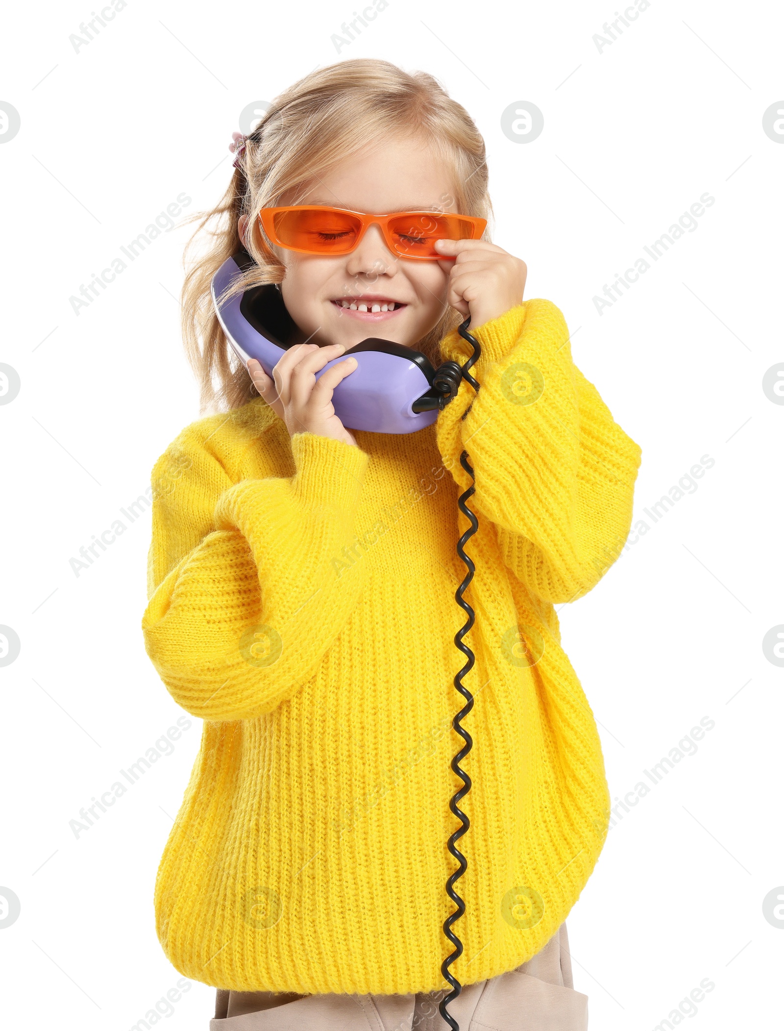 Photo of Cute little girl with handset of telephone on white background