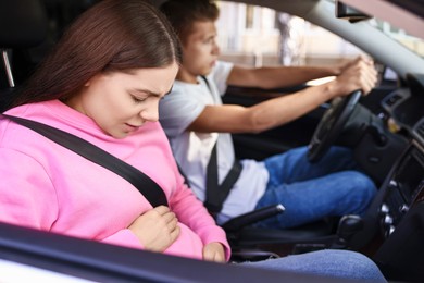 Photo of Pregnant woman travelling with her husband by car