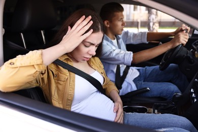 Photo of Pregnant woman travelling with her husband by car